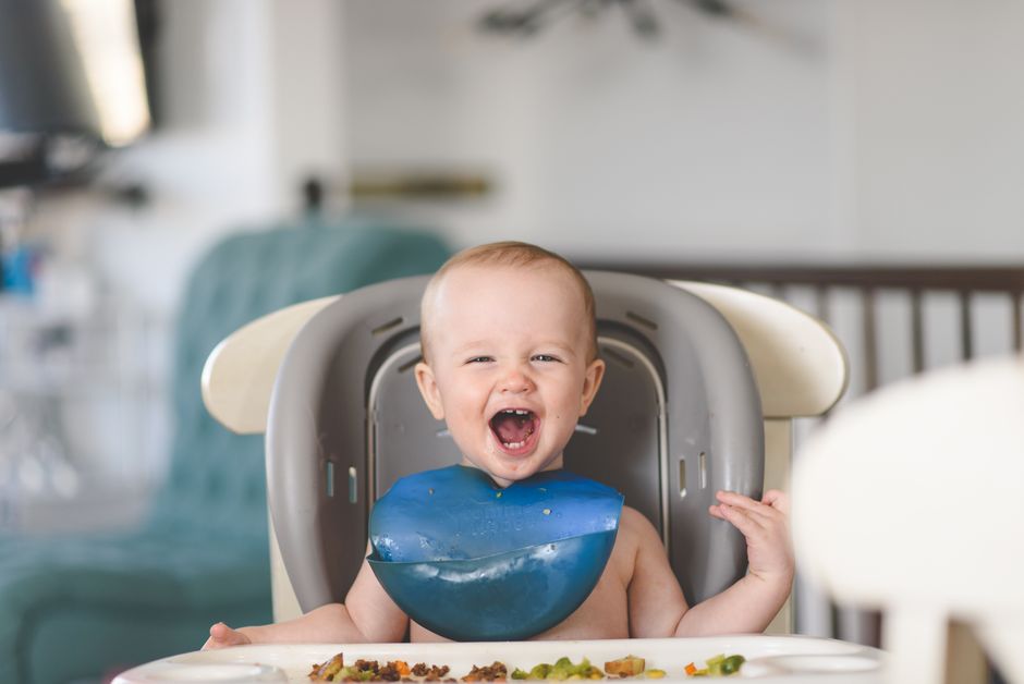 Baby happily making a mess while eating